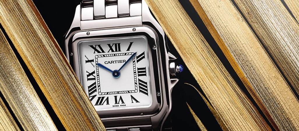 silver Cartier watch with roman numeral numbers