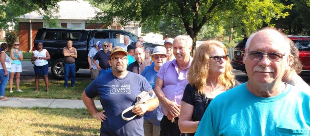 group of estate sale shoppers in a line awaiting entrance to a home
