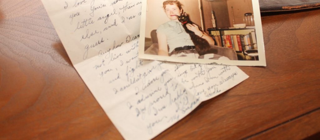 old handwritten letter with photograph of woman and black cat