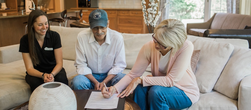 Owner Allison with clients signing a contract