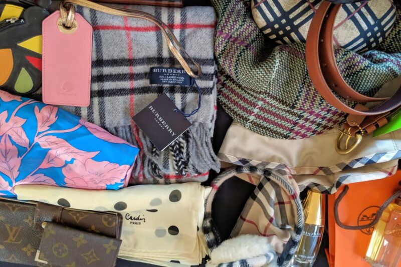 a collection of scarves and purses