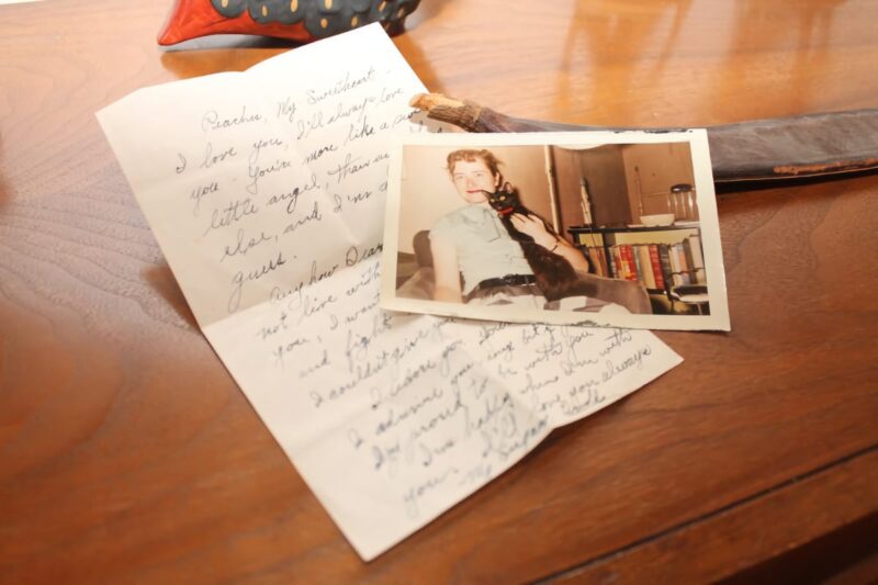 old handwritten letter with photograph of woman and black cat