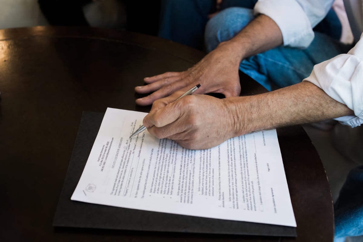 person signing a contract