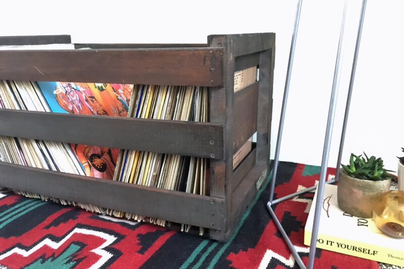 wooden crate of records on a vintage native rug