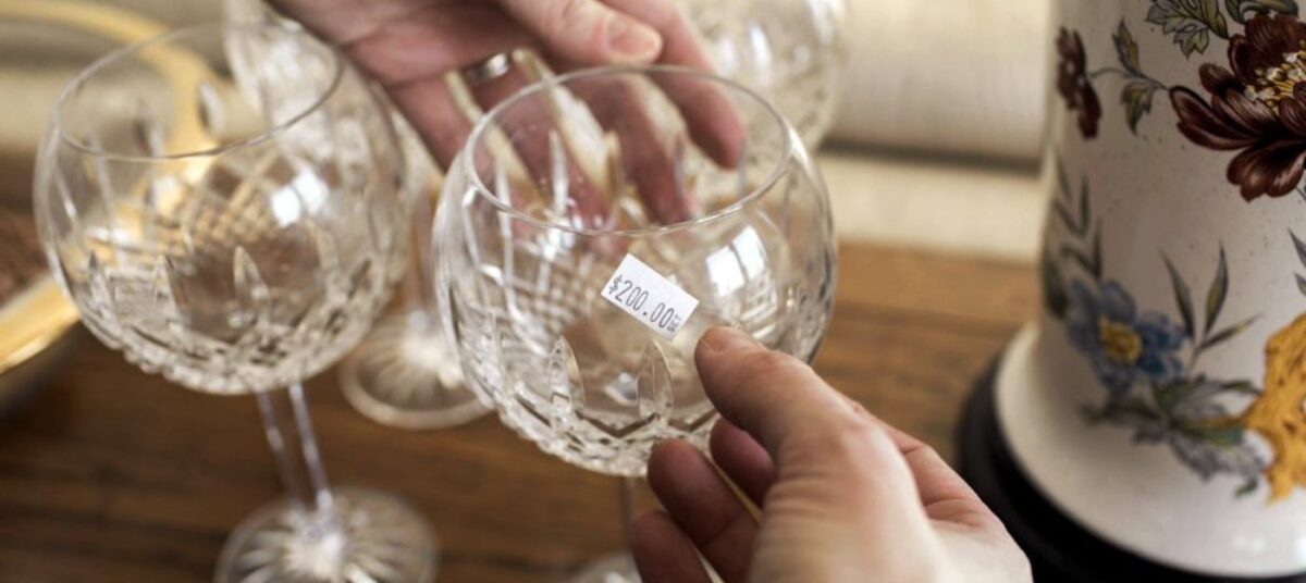 Glass stem wear on a table being priced with a sticker