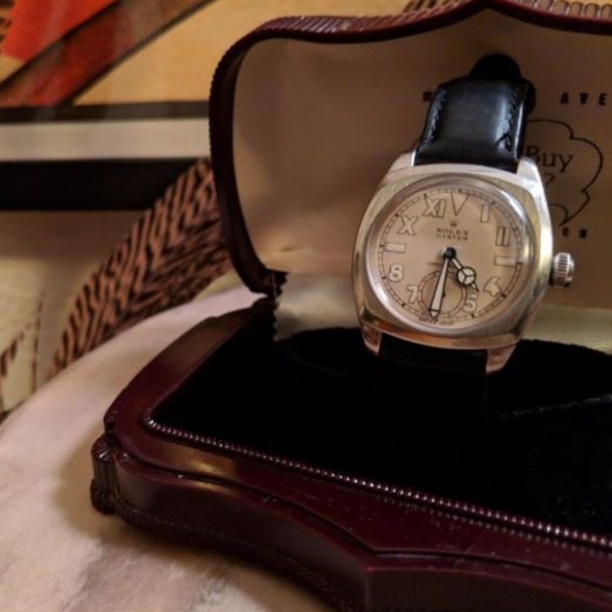 Rolex watch in a case sitting on a table