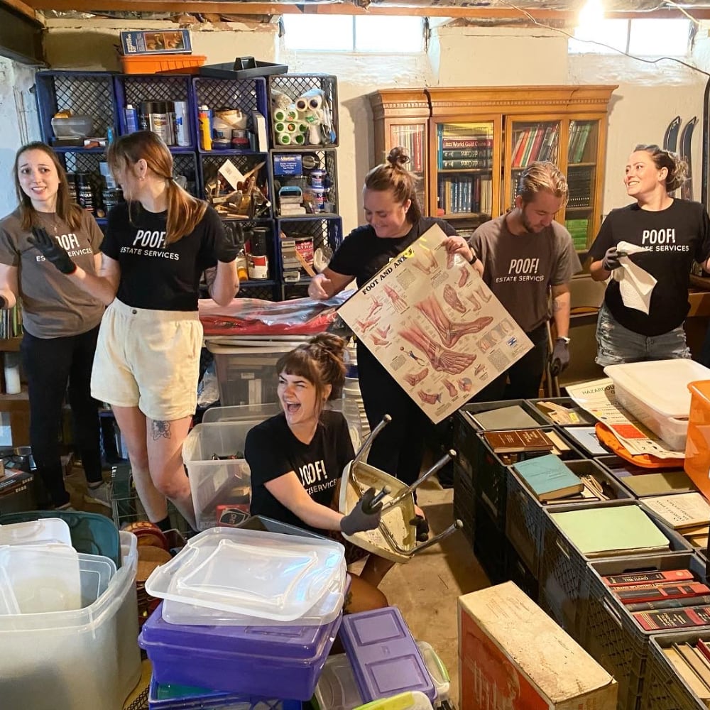 A group of young Poof employees sorting through items in a basement