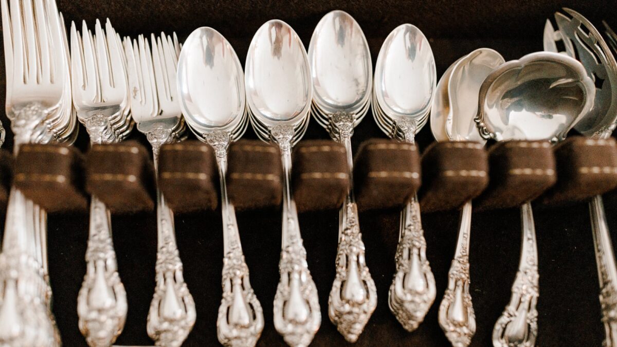 Up close photo of silverware on black velvet