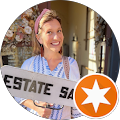 smiling young woman holding an estate sale sign