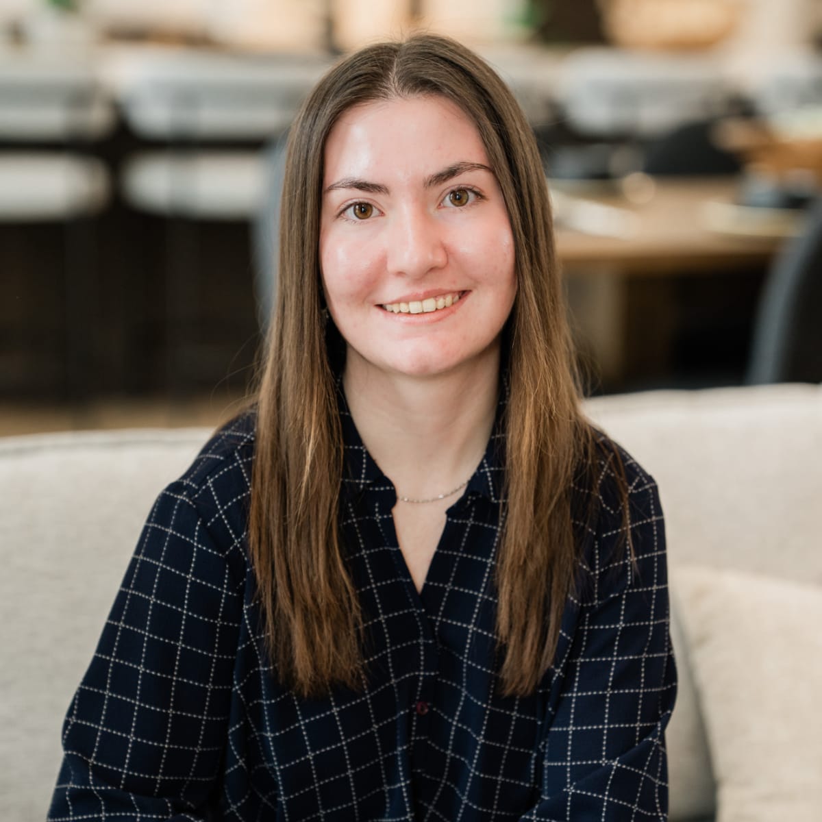 Annabelle Tyrrell, Assistant Manager and Certified Appraiser for Poof Estate Services; young smiling woman with long brown hair