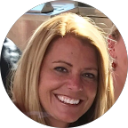 Buffy Hurd, a blonde woman, smiles broadly while looking directly at the camera.